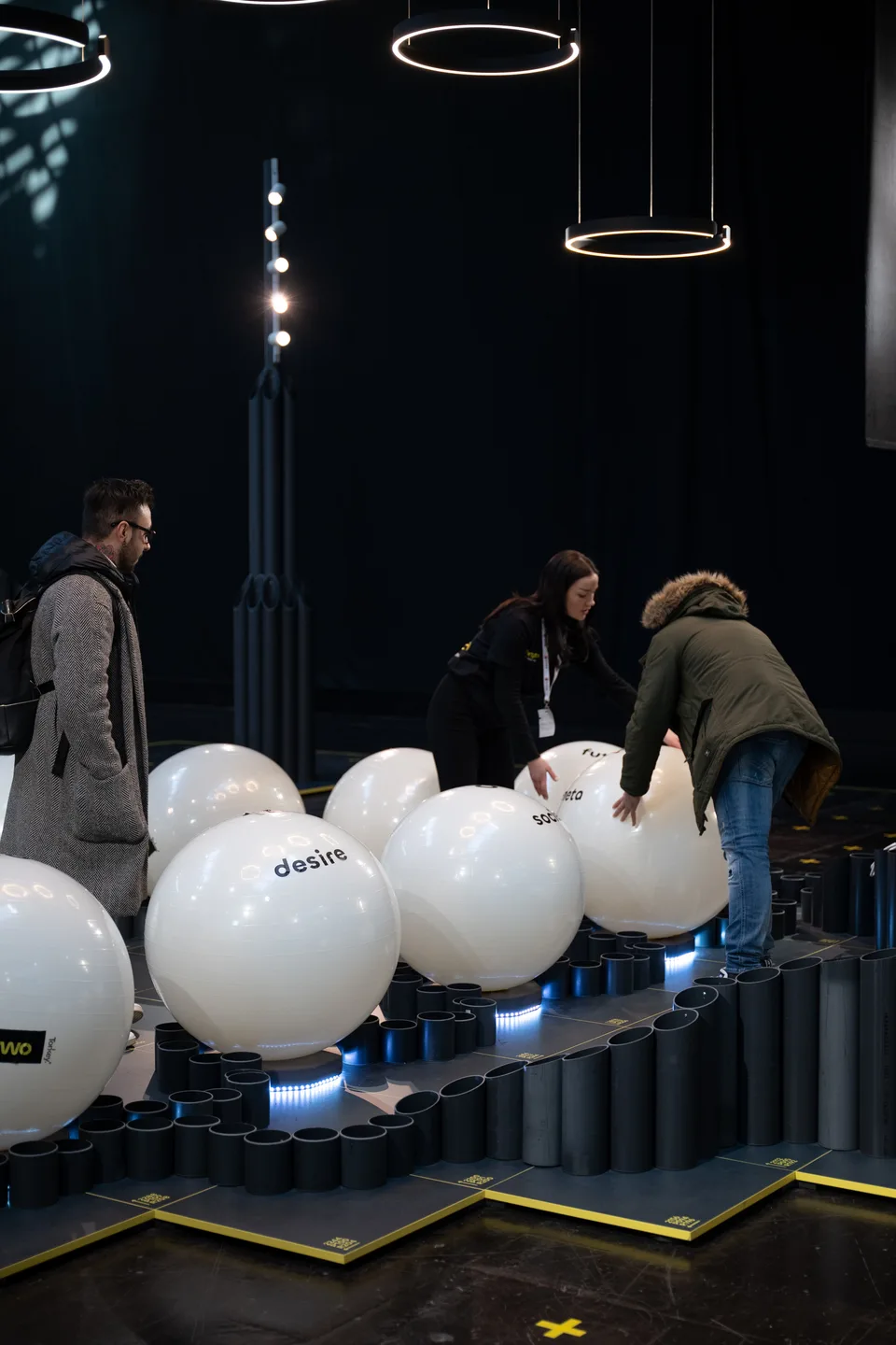 Forty Two Trade, event and structure: visitors playing with white balls on a track at the stand