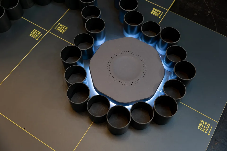 Forty Two Trade, event and structure: detail of the ball track with black cups arranged in a circle and yellow lines