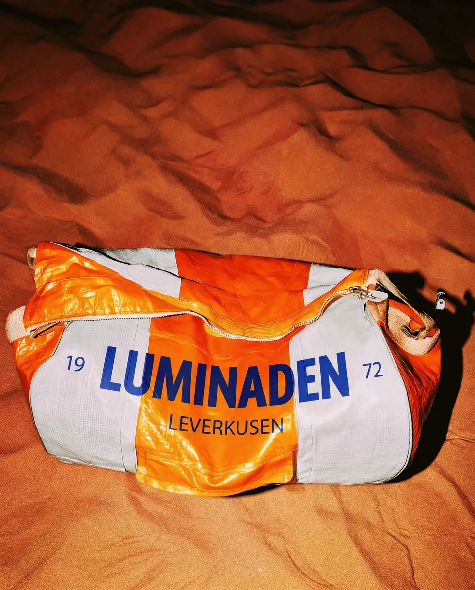 Luminaden, brand space: sports bag with the Luminaden logo on orange fabric
