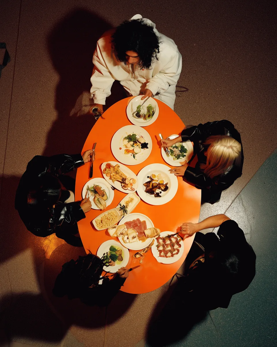 Luminaden, brand space: table with dishes seen from above, people eating together